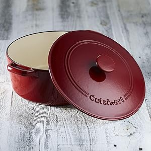 Red enameled cast iron oval Dutch oven with lid, featuring the Cuisinart logo.